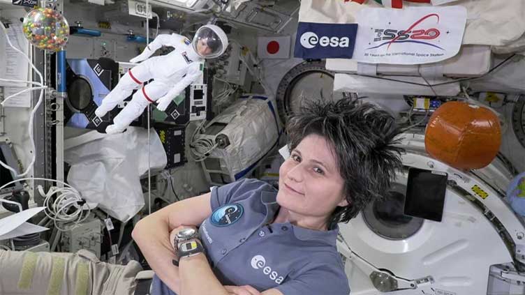  Space station's Italian commander, with lookalike Barbie, tells girls about science in orbit