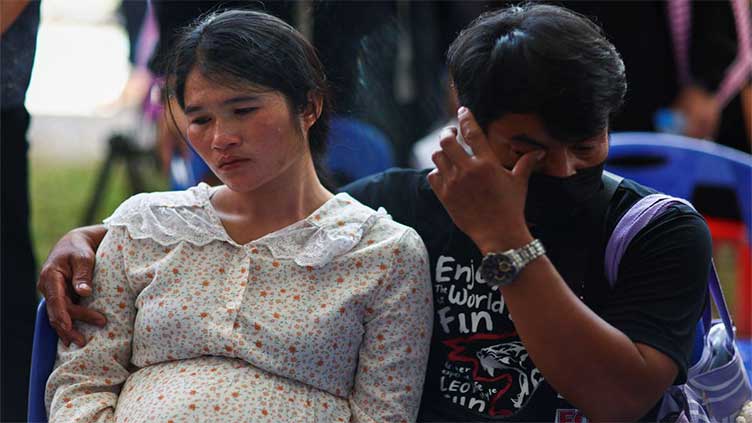 Day after Thai attack, traumatised relatives cling to slain childrens' toys