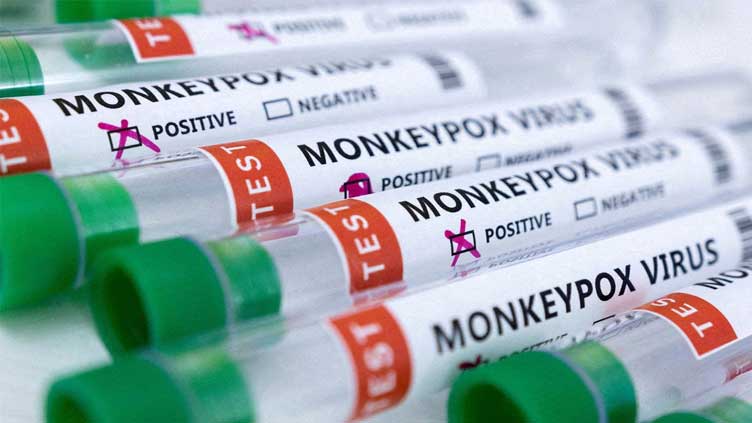 Multiple Monkeypox test tubes with some marked positive and some marked negative.