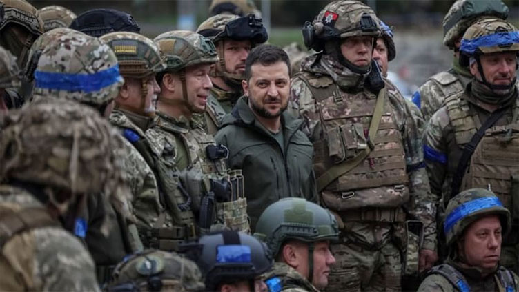 Ukraine leader promises victory during frontline town visit as Russia digs in