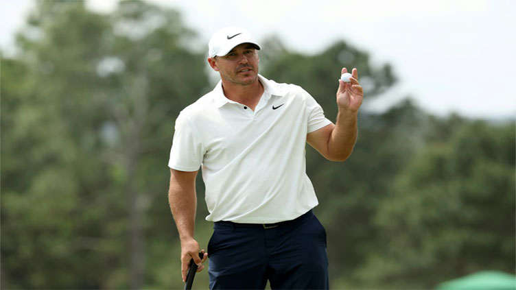 Koepka storms into Masters lead before weather halts play