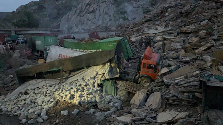 Two die as landslide in Torkham buries 15 trucks, containers