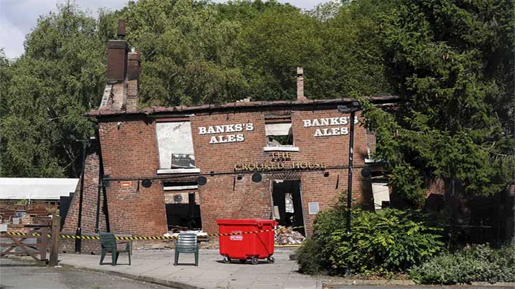 Police arrest two men in suspected torching of British pub cherished for lopsided walls