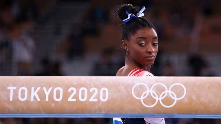 Biles leads US gymnastics championships at halfway stage