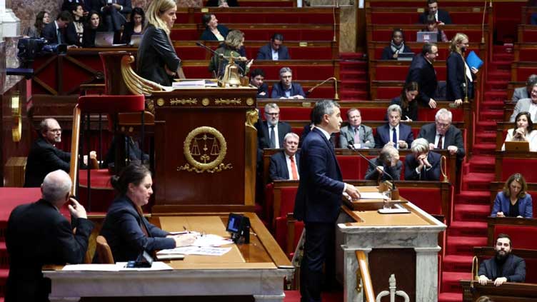 French lawmakers fight to break deadlock over Macron's flagship immigration law