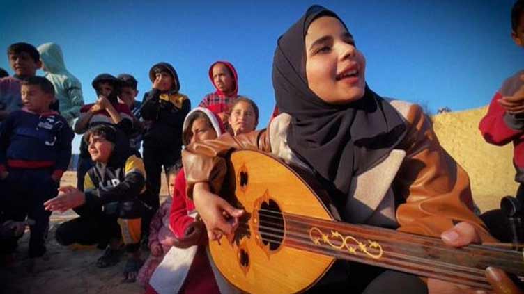 Music therapy - Palestinian girl shields children from horrors of war