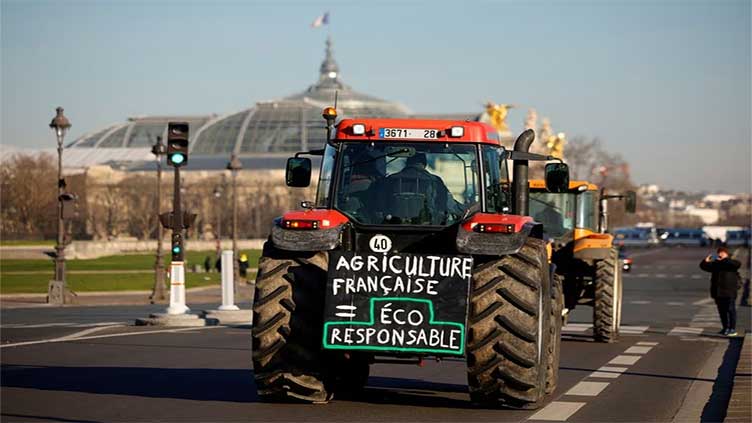 Farmers drive tractors through Paris in protest at pesticide bans