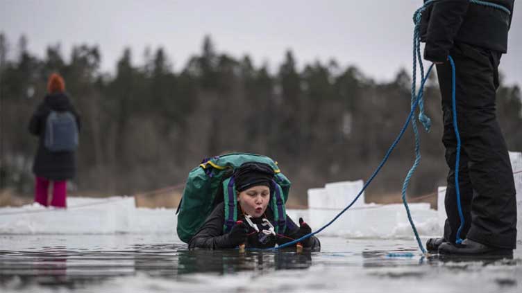  Swedish kids take the plunge in icy lake survival lessons