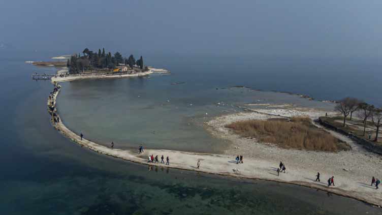 Lake Garda tourists flock to island reconnected by drought