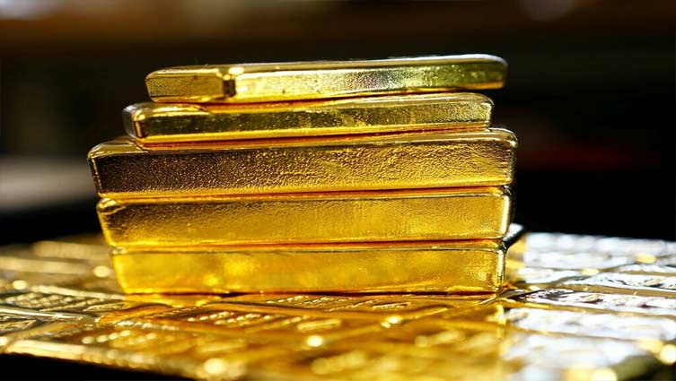 Gold edges up as dollar weakens, rate-hike worries cap gains