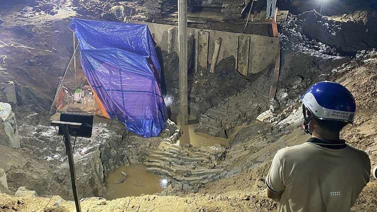 Rescuers in Vietnam try to save boy trapped in concrete pile