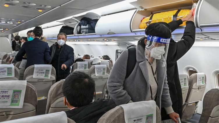 China ends quarantine for overseas travellers