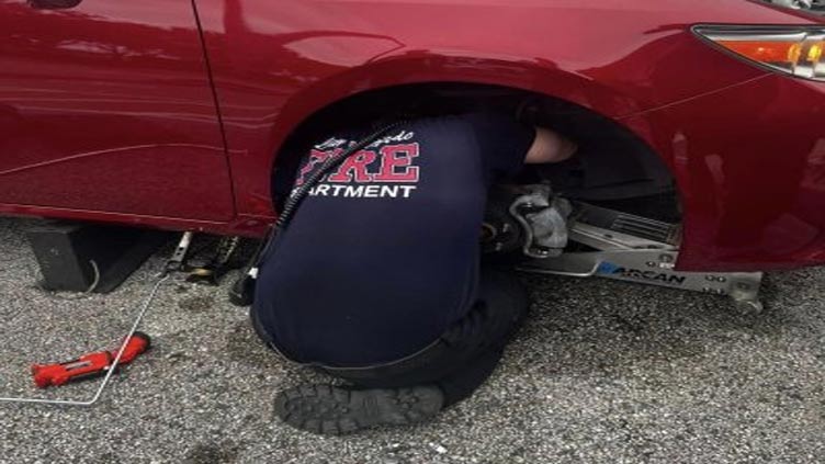 Firefighters remove wheel from car to rescue kitten