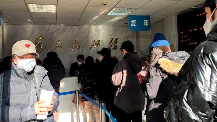 Chinese rush to renew passports as COVID border curbs lifted