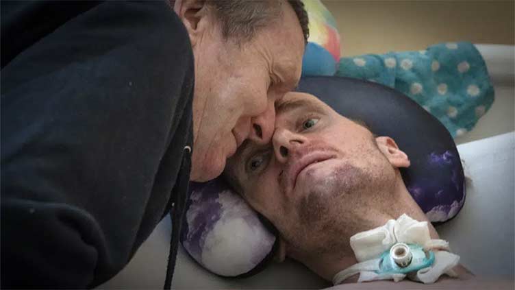 A loving dad and his injured son pay war's costs in Ukraine