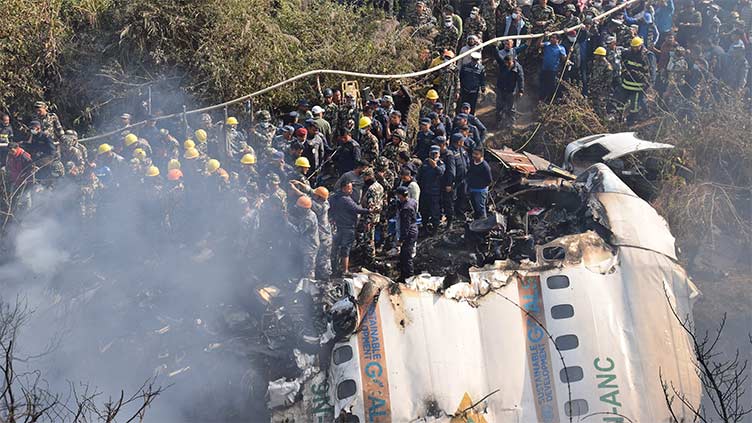 Nepal plane crash searchers rappel, fly drones to find last two people