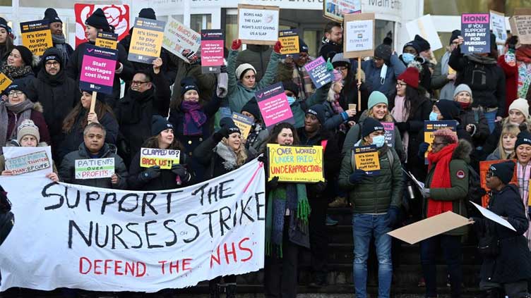  Exhausted and struggling to pay bills, British nurses go on strike