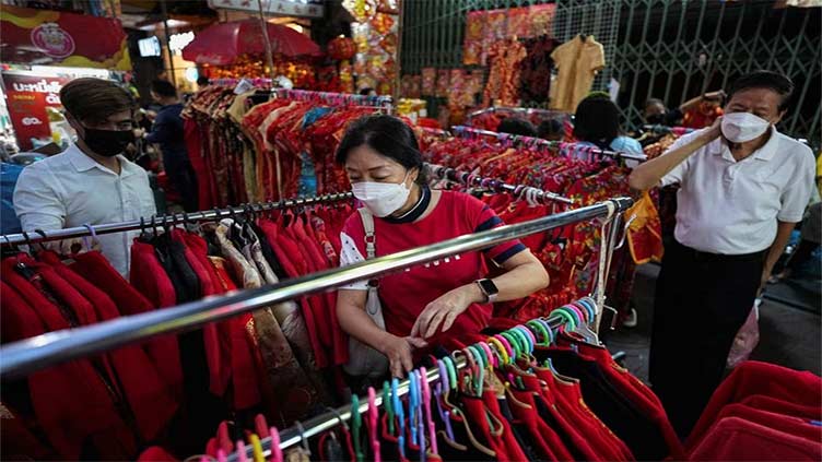 For Chinese Lunar New Year tourists, retailers roll out rabbit dances, red lanterns