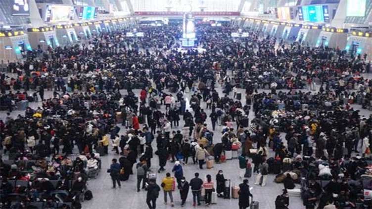China plays down COVID outbreak with holiday rush at full tilt