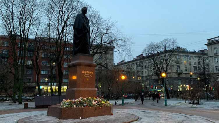 Russians lay flowers at improvised memorials to commemorate Dnipro dead