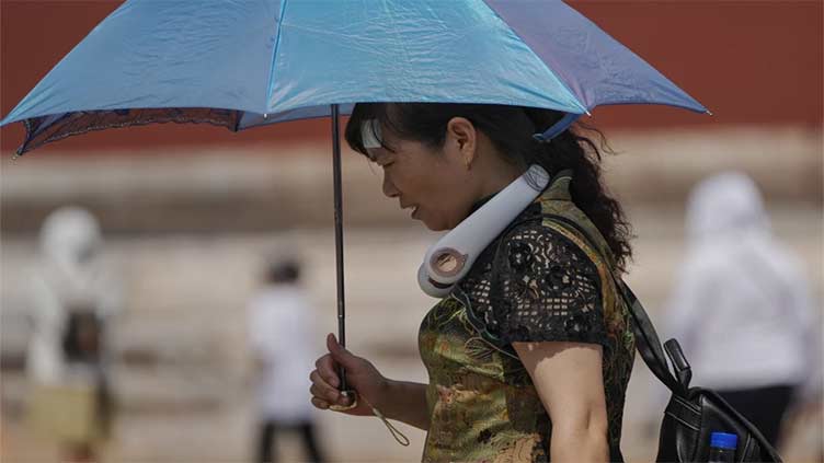 Nine missing in China landslide sparked by heavy rains amid flooding and searing temperatures