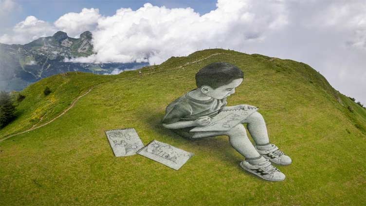 In Switzerland, an artist uses mountain slopes as his canvas