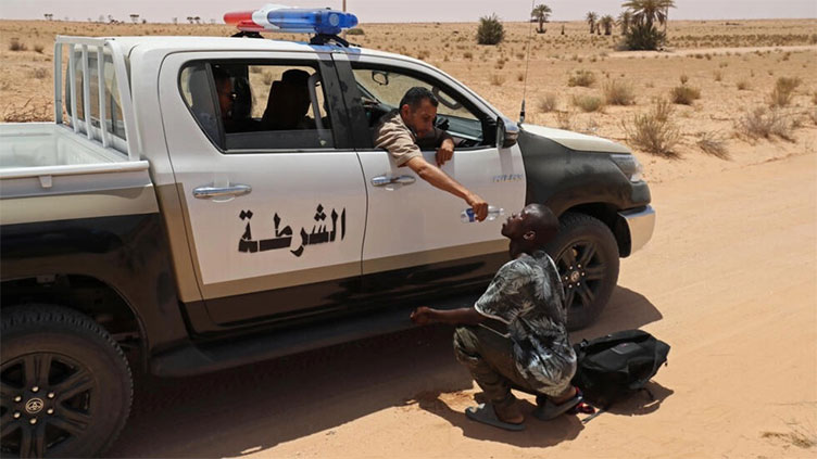 Libya border guards rescue migrants in desert near Tunisia
