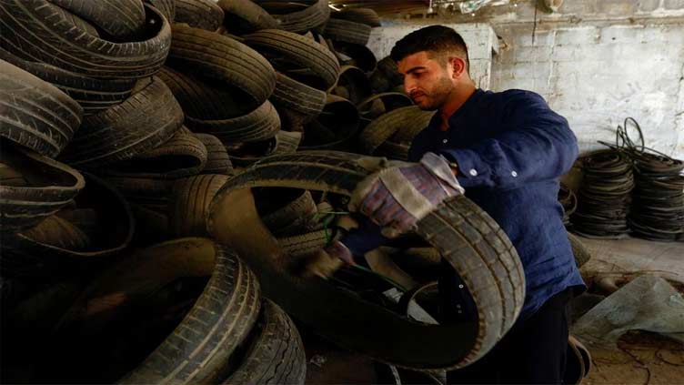 Gaza man turns waste car tyres into materials for sports pitches