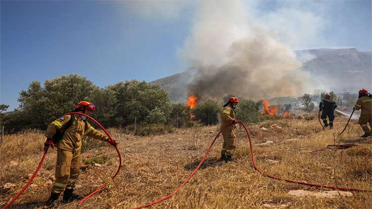 Wildfires rage near Greek capital, houses damaged