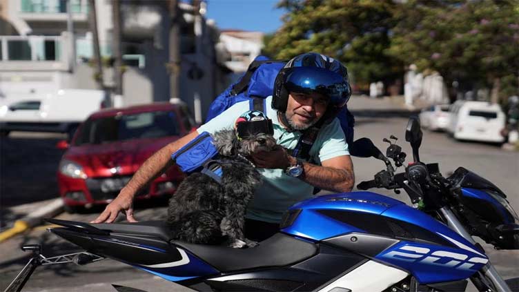 Motor-biking dog and owner cruise Brazil's streets to help hungry pups