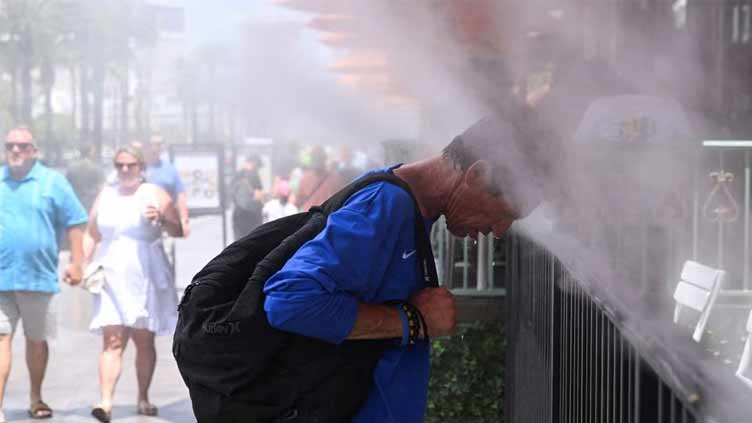 US hit by blazing heat, smoky air, tropical storm all at once