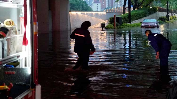 Chinese cities brace for floods as heat scorches inland regions