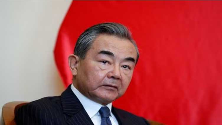 China appoints Wang Yi as its new foreign minister, replacing absent Qin Gang