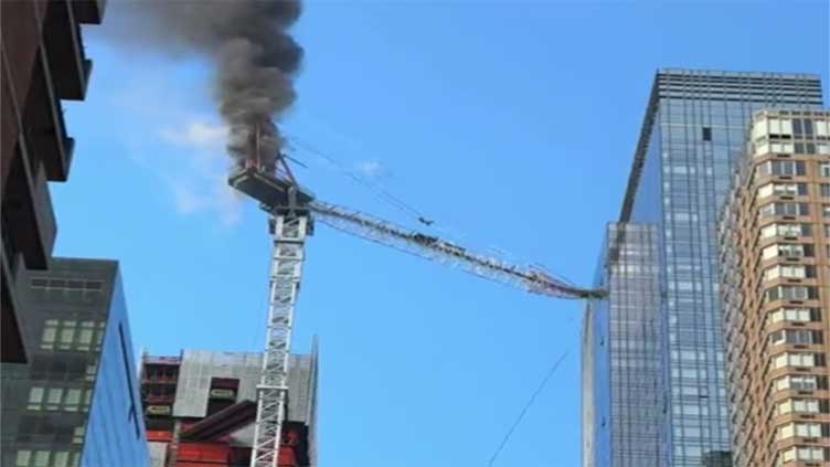 Pedestrians scatter as fire causes New York construction crane's arm to collapse and crash to street