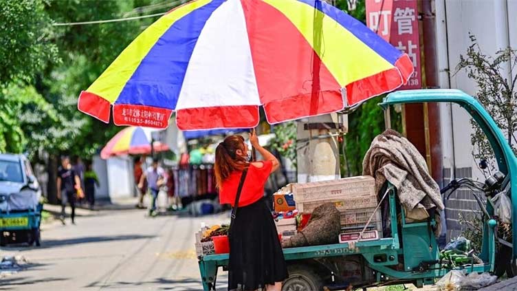 Beijing roasts in record mid-June temperatures