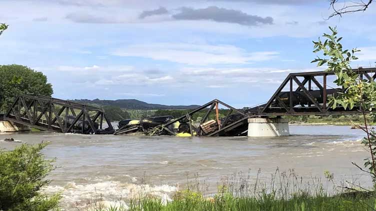 A bridge over Yellowstone River collapses, sending a freight train into the waters below