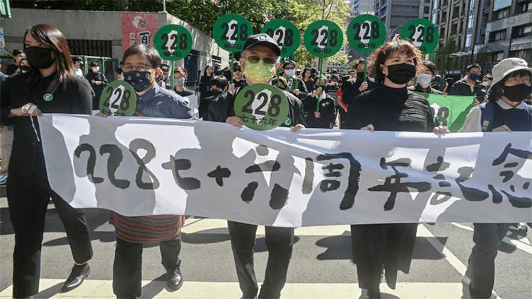 Protesters storm stage at Taiwan massacre memorial