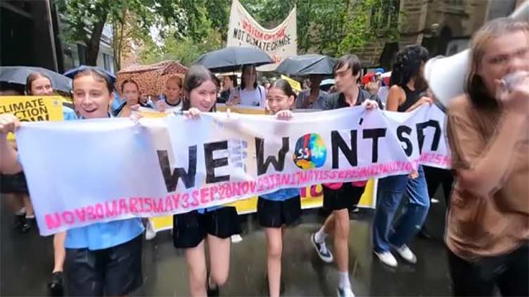 Climate activists in Australia protest in rain