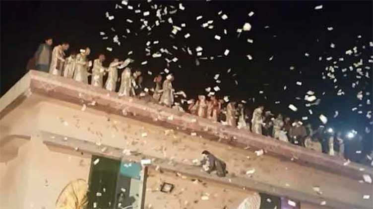 MANDI BAHAUDDIN: Rupees, phones distributed among people in marriage