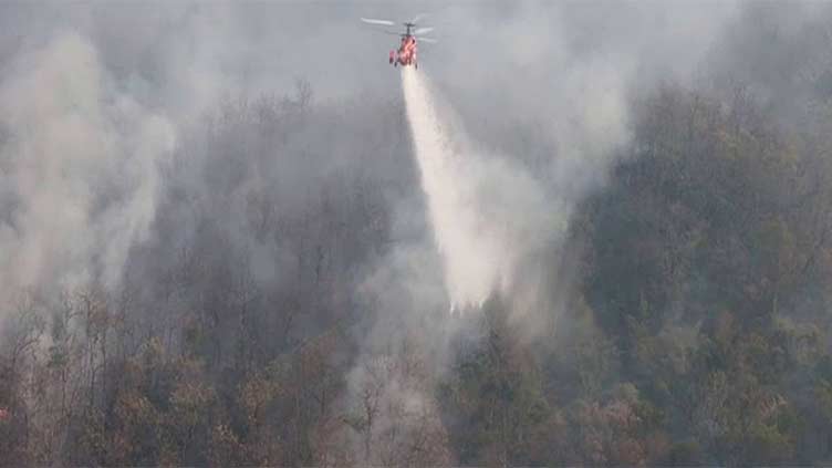 Helicopters battle fires started by farmers in northern Thailand