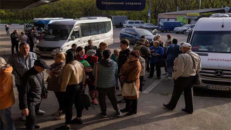 Cars and small buses leave Ukraine's Kherson before curfew