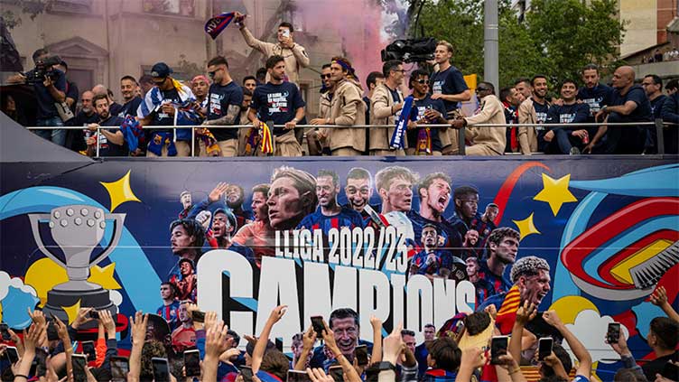 Barca fans celebrate league titles with players in parade