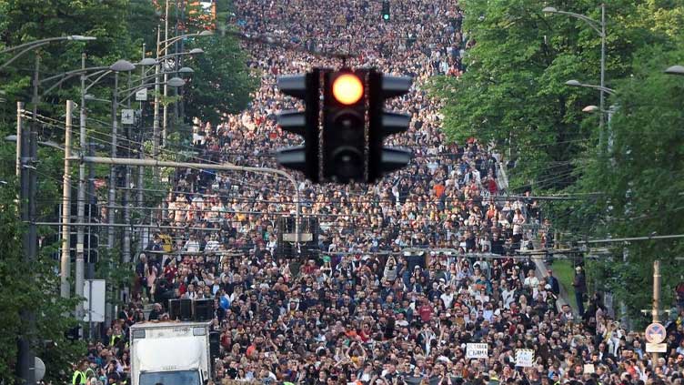 Tens of thousands gather in Belgrade protest over mass shootings