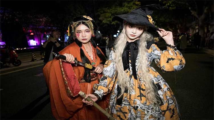 Halloween revellers throng Shanghai, some wearing costumes seen as a protest to China policies