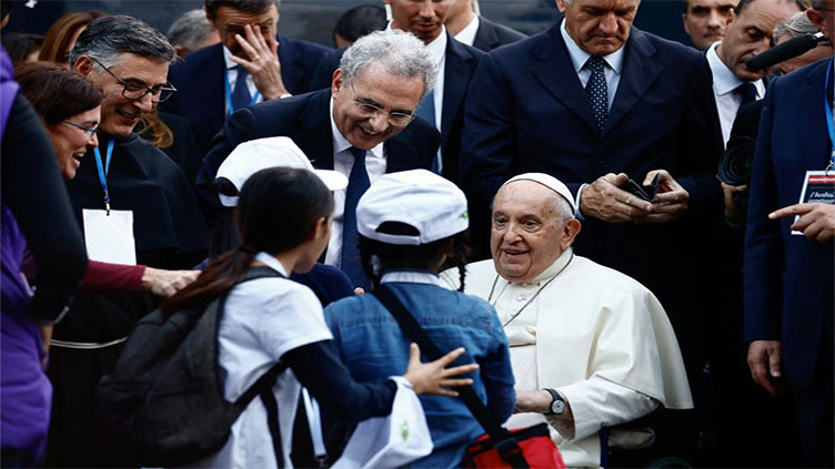Pope talks and jokes with children at rally after brief health scare