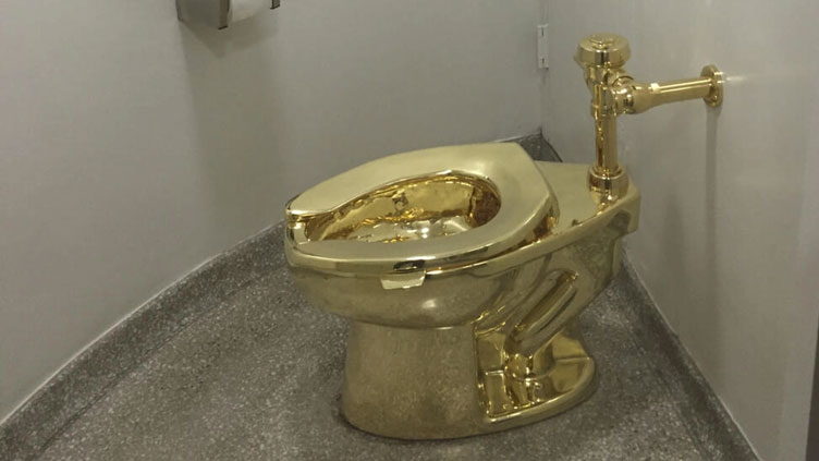 Four charged with theft of gold toilet from English stately home