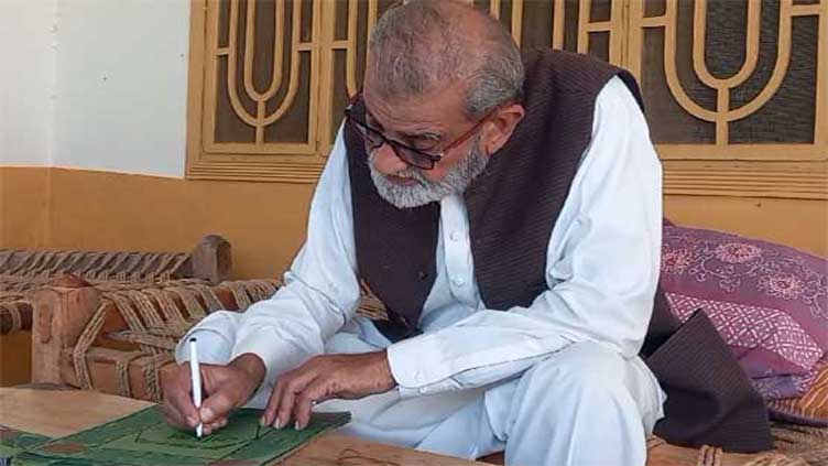 Swabi man writes glorious Quran with hand