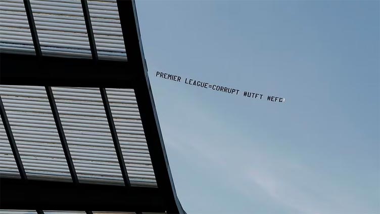 Protest banners fly over Etihad Stadium during Man City game