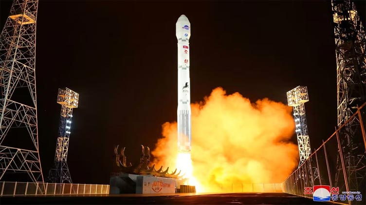 North Korea lashes out at critics, hints at more satellite launches