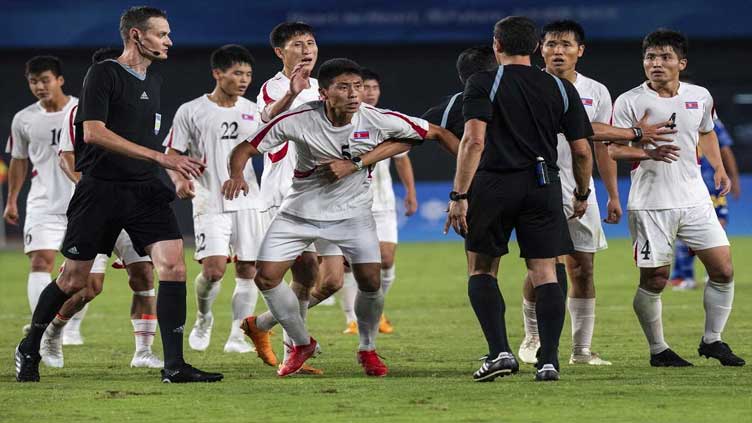 North Korean soccer players clash with referee after losing to Japan